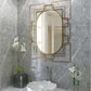 Gild Design House Deanna Gold Wall Mirror in bathroom with art deco frame and orchid decor.
