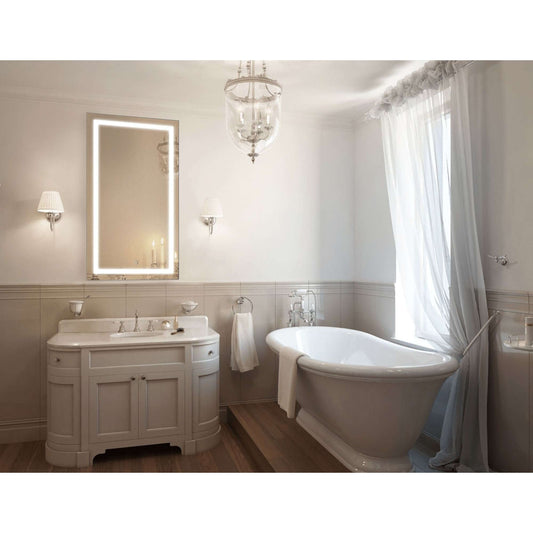 Krugg Icon 24 x 42 LED Bathroom Mirror with Dimmer and Defogger in a modern white bathroom featuring a freestanding bathtub and elegant lighting.